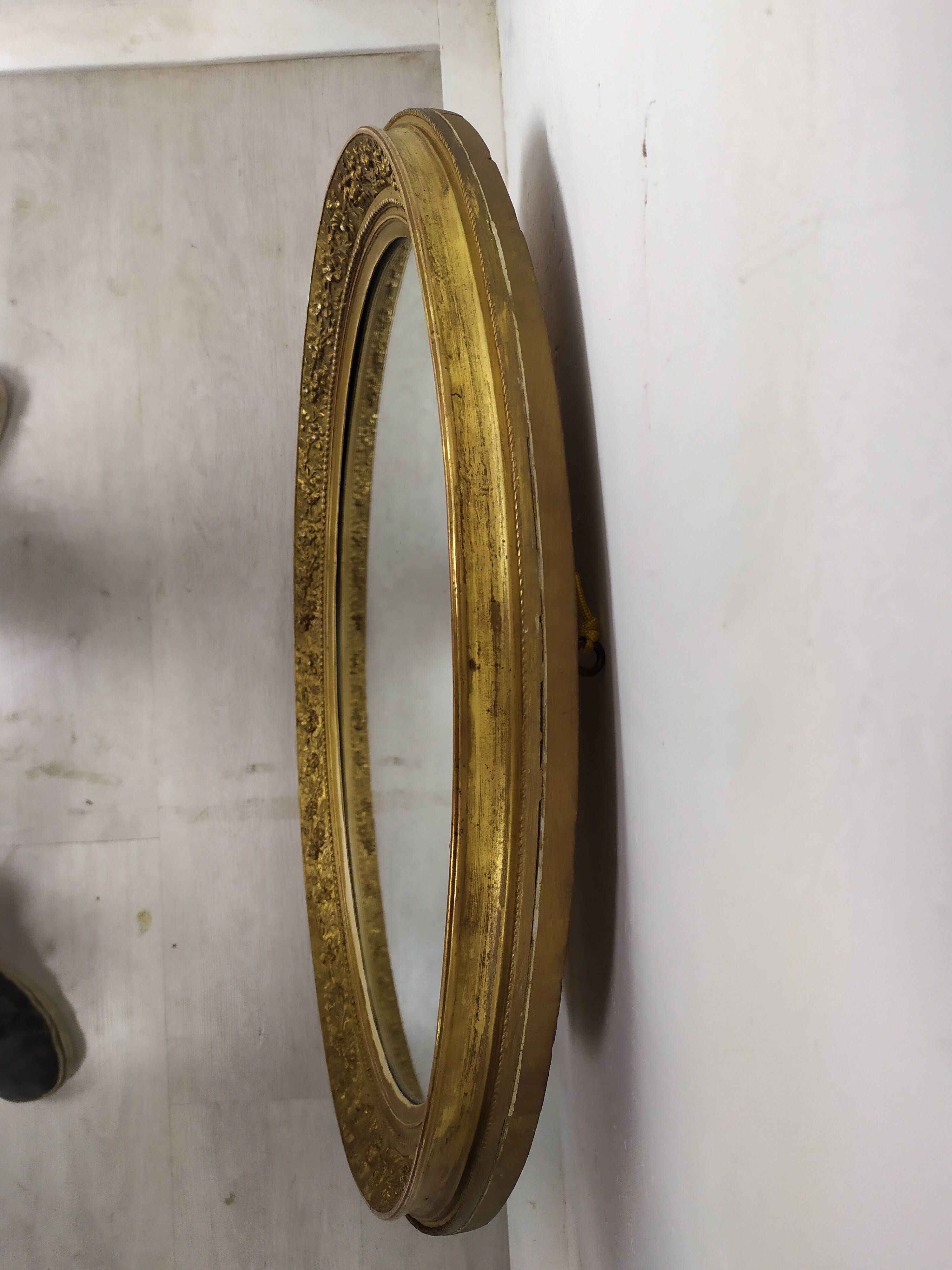 Golden oval mirror