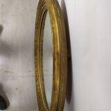 Golden oval mirror