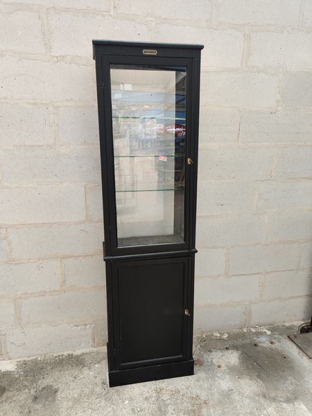 Old wooden window of black patina store two doors
