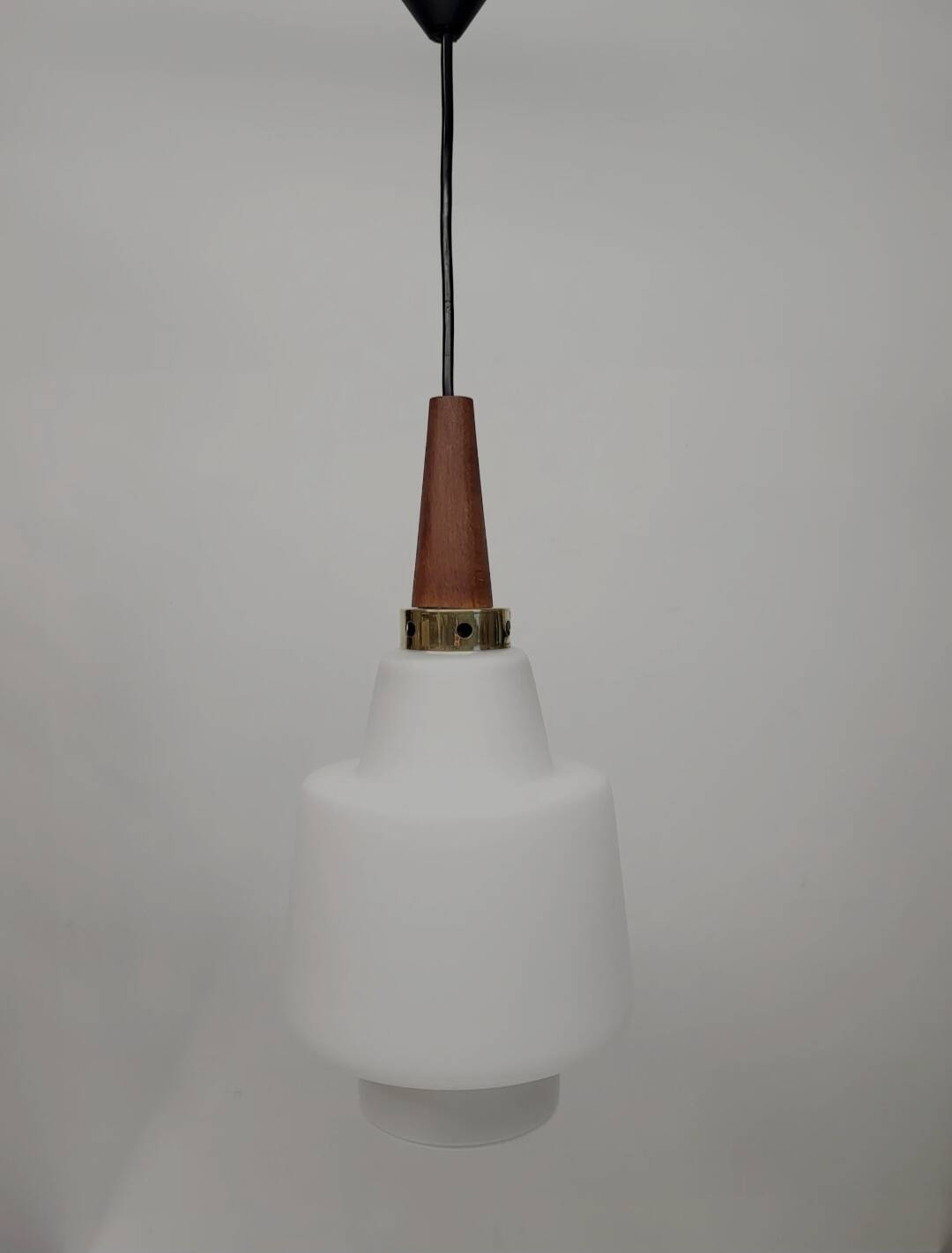 Scandinavian pendant light in opaline and teak, around 1960.