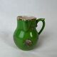 Green milk jug with enamelled flowers