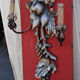 Large three-light wall sconce in silver wood with fruit decoration.