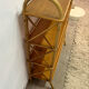 Vintage shelf on legs made of rattan and wood.