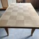 Oak dining table with a checkerboard top and extensions.