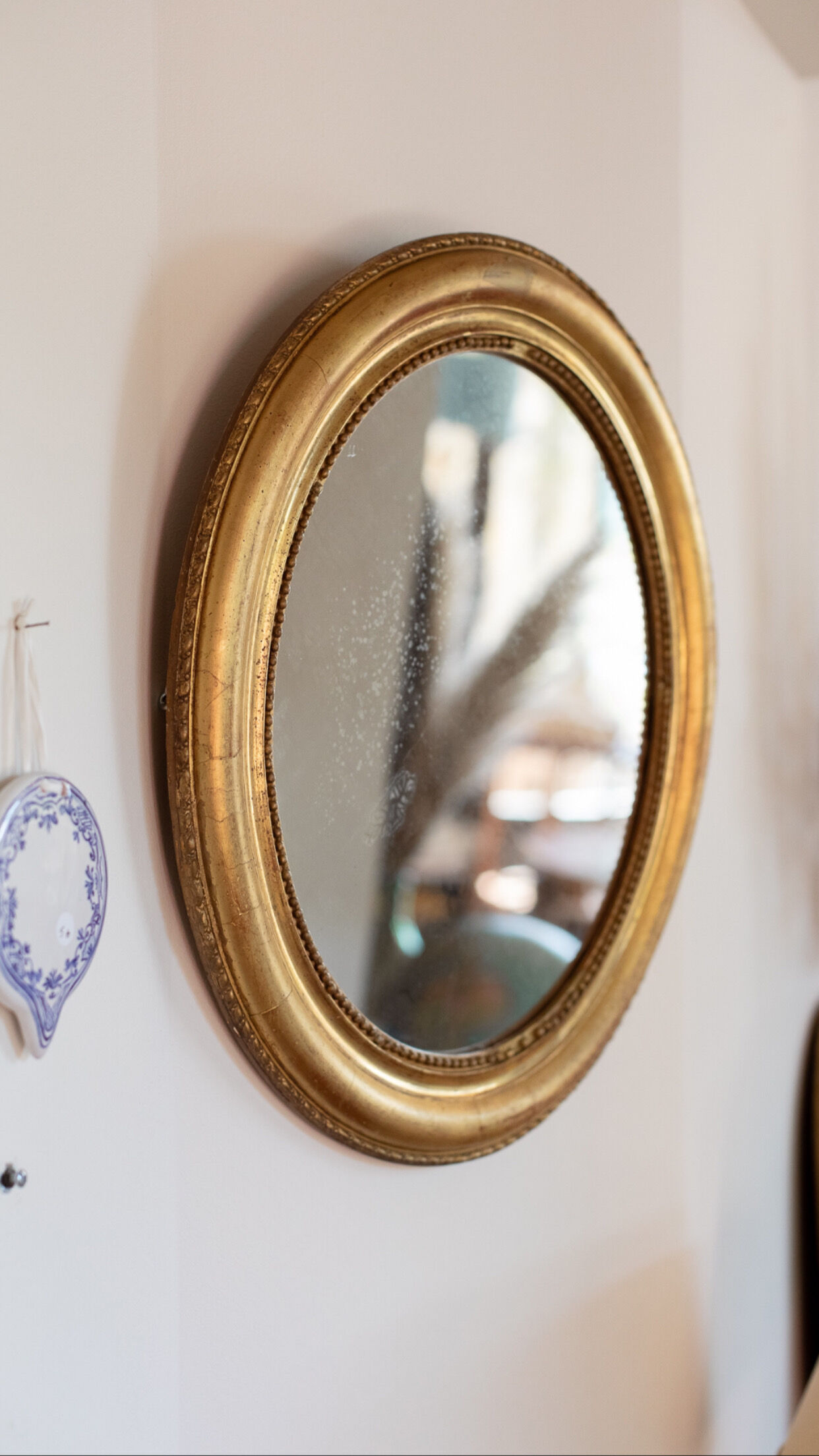 Oval mirror in gilded wood late 19th