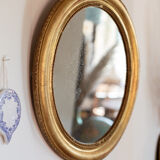 Oval mirror in gilded wood late 19th