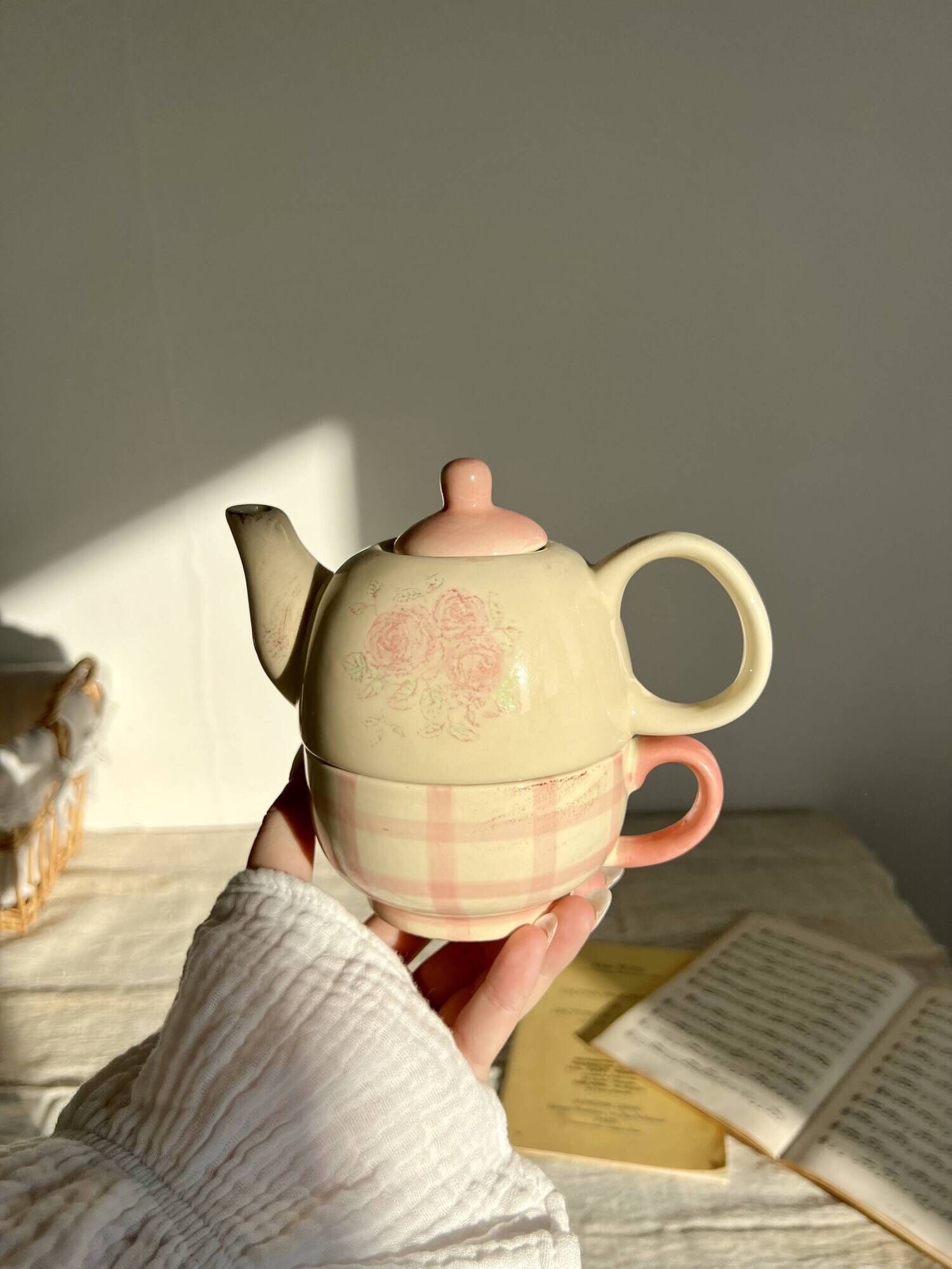 Vintage porcelain teapot and cup set with pink and beige floral and gingham pattern