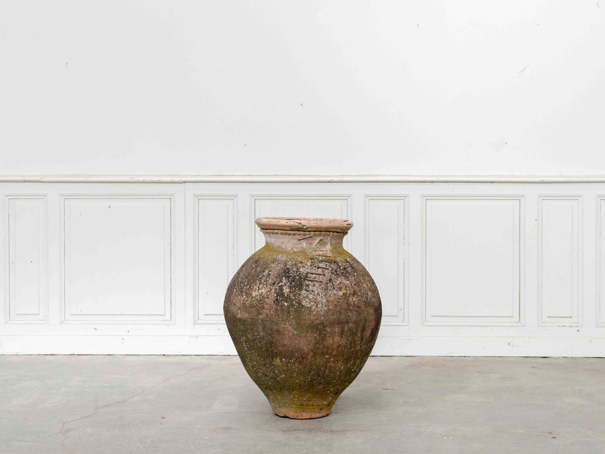 Old terracotta jar with its metal clasps, late 19th century.