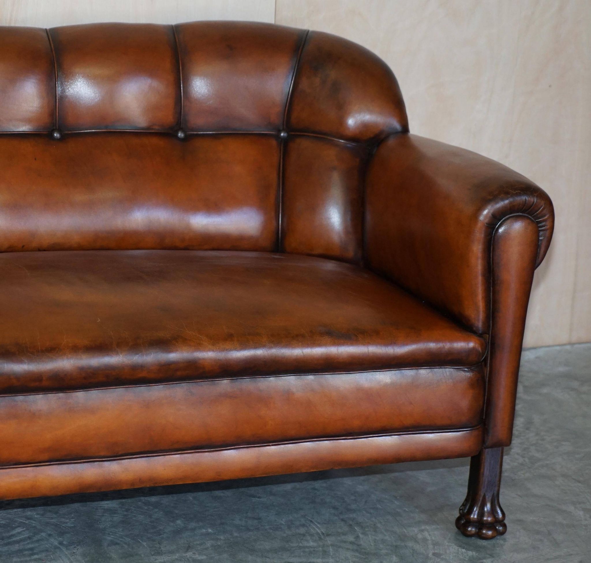 Victorian Chesterfield leather canapé with oak lion claw feet.
