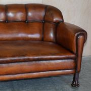 Victorian Chesterfield leather canapé with oak lion claw feet.