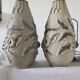 Pair of white glazed stoneware lamp bases, 20th-century floral decoration.