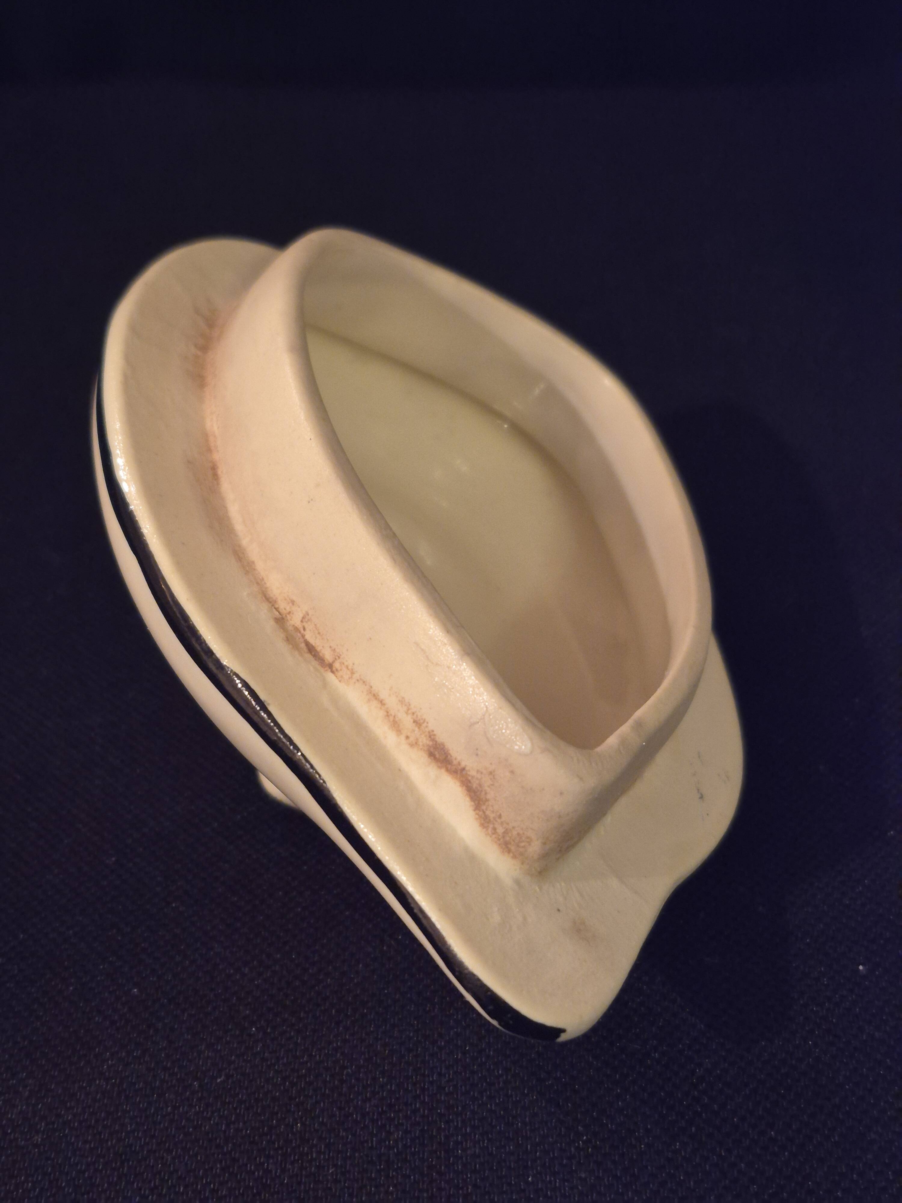 Old covered jug, vintage, geometric frieze with flowers and black trim.