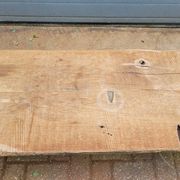 French country-style cast iron garden bench with old barn wood plank.