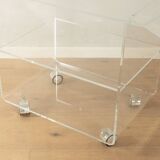 Wonderful side table from the 1960s, high-quality frame and shelf made of transparent acrylic with chrome-plated castors