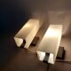 Pair of modernist sconces in black metal and white opaline vintage