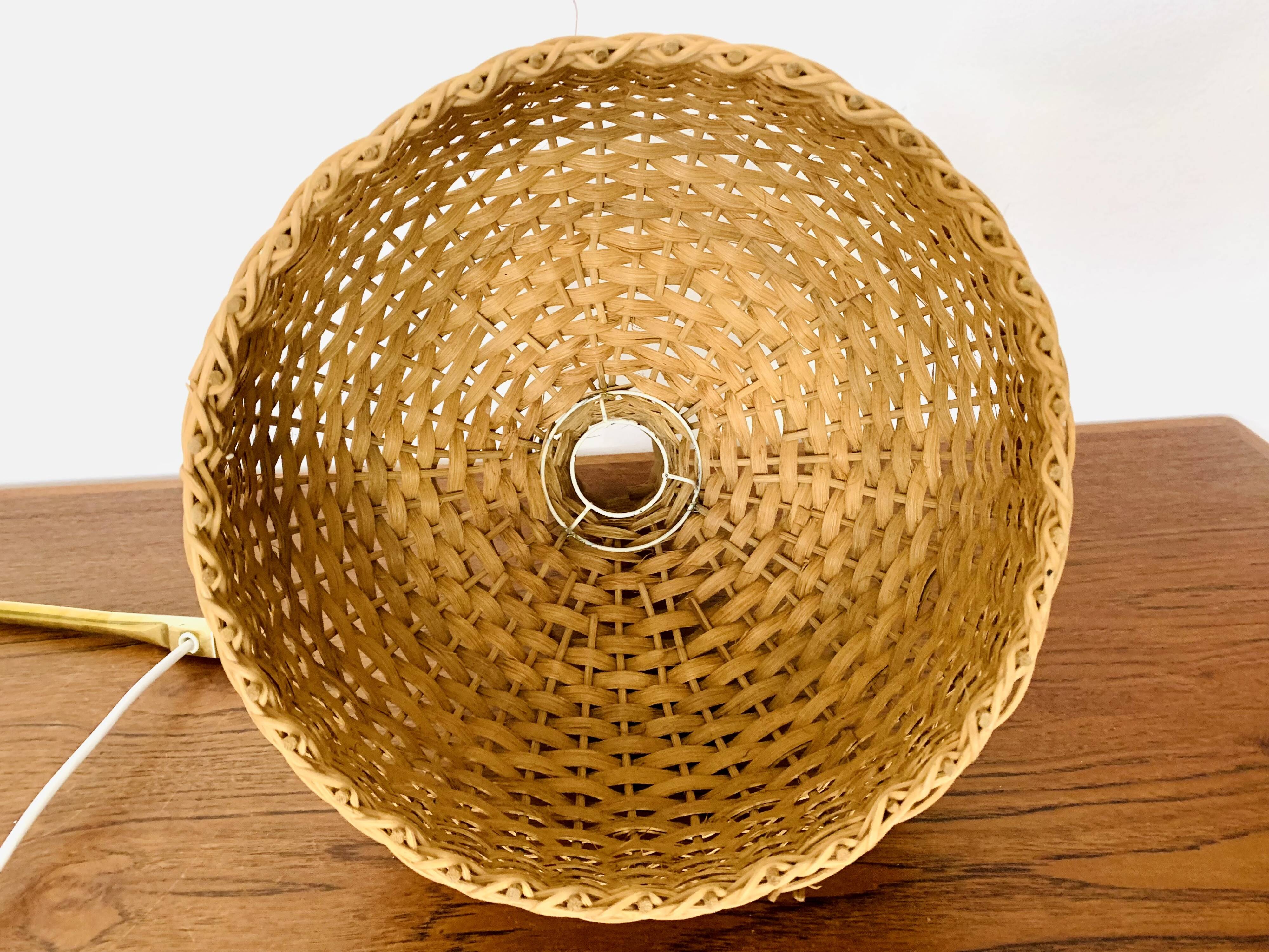Adjustable Brass and Wicker Arc Sconce