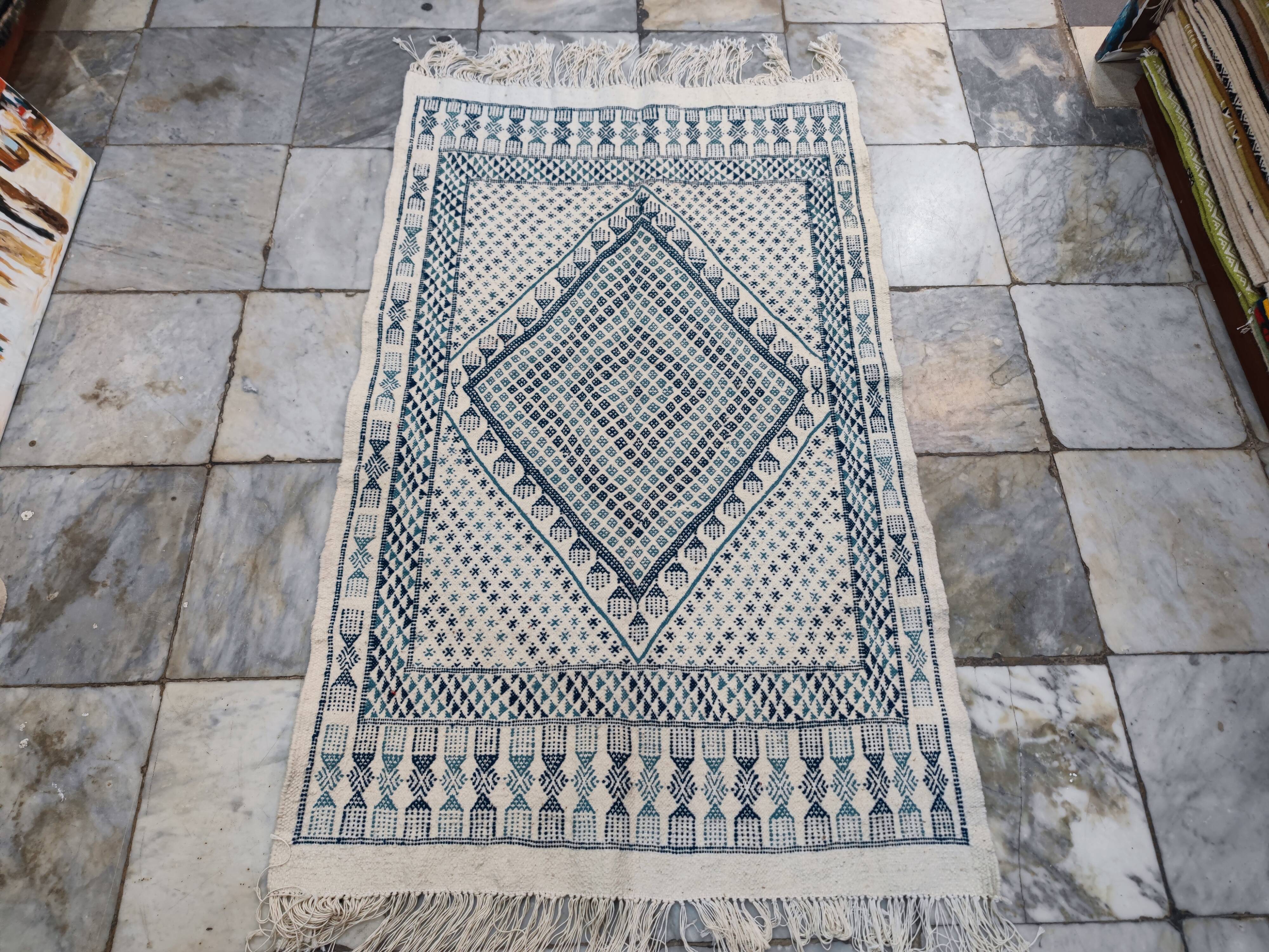 White and blue handwoven rug in natural wool