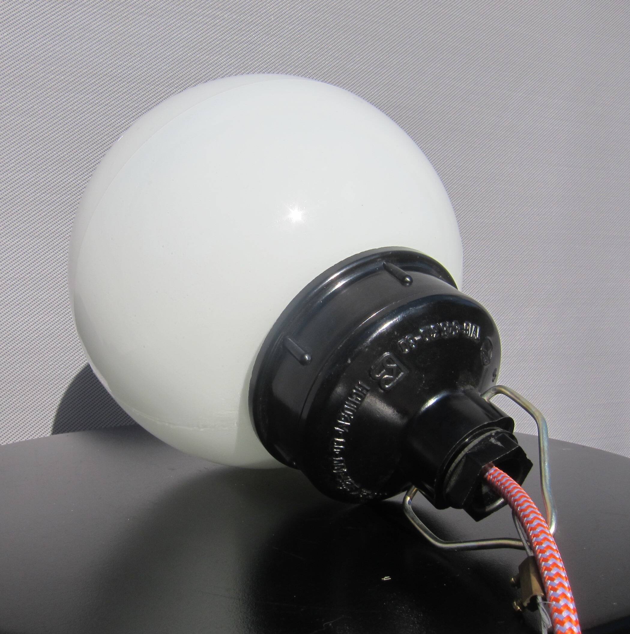 Trio of opal glass and bakelite globe pendant lights