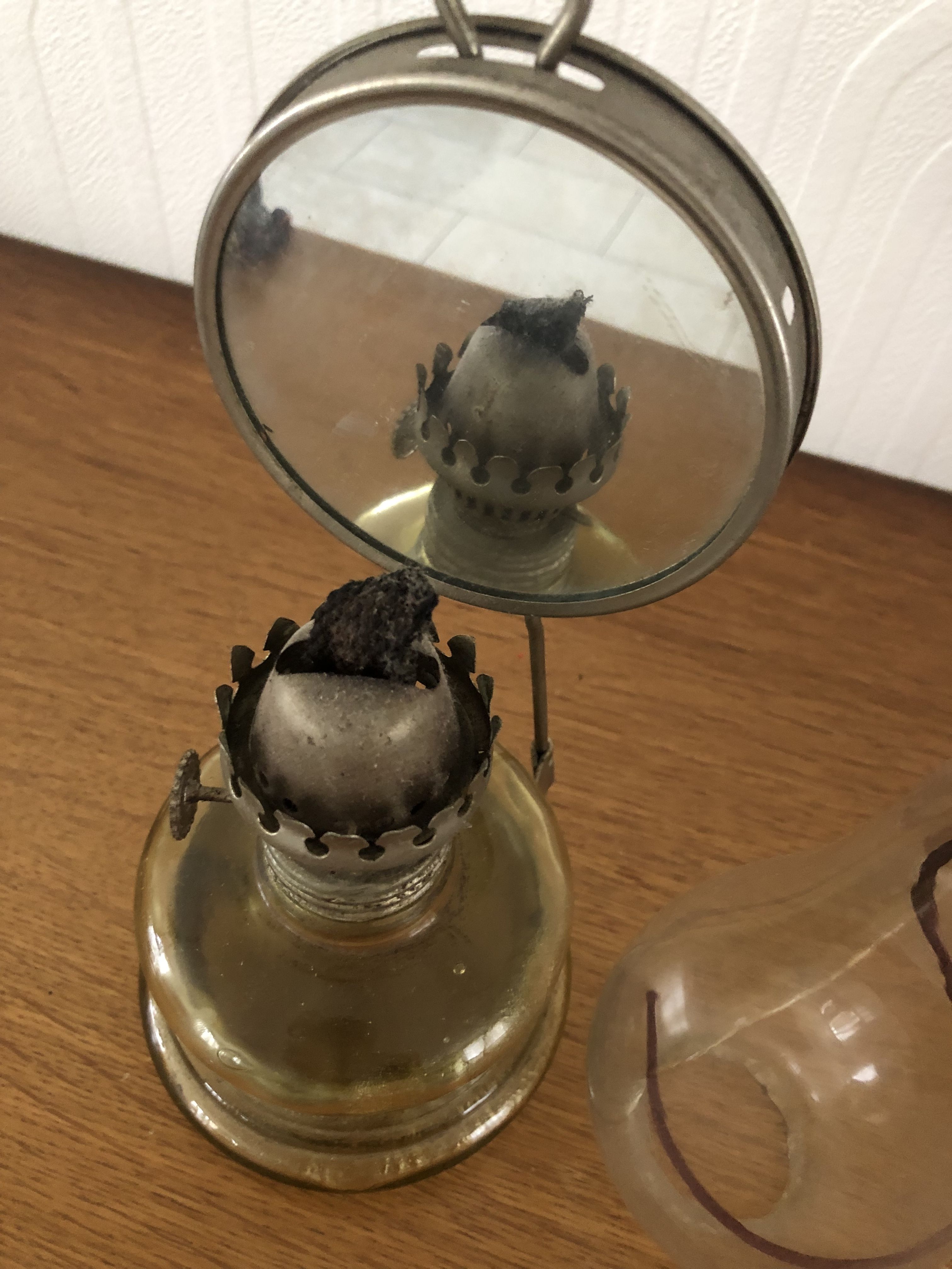 Oil lamp with glass pedestal and integrated round mirror