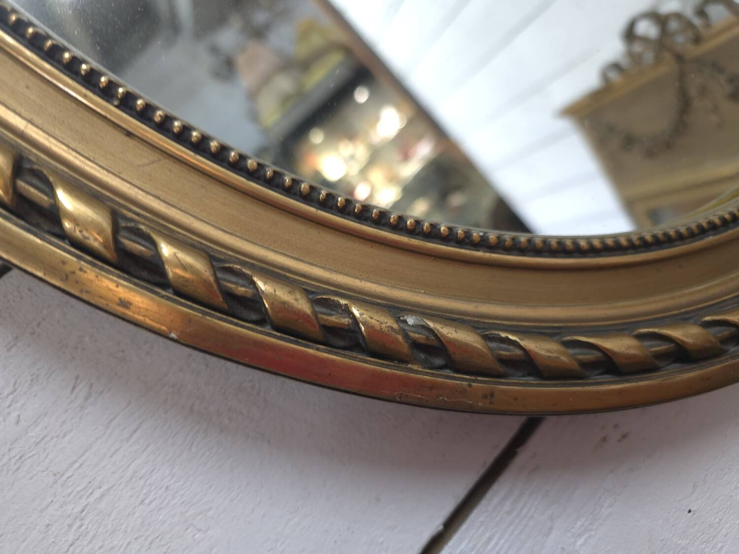 Oval mirror with gold patina