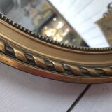 Oval mirror with gold patina