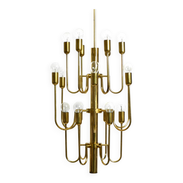 Three staged 18 arm Mid Century brass chandelier with a long brass rod