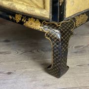 A set of two armchairs, a sofa and two poufs in lacquered wood with gilded chinoiserie decoration.