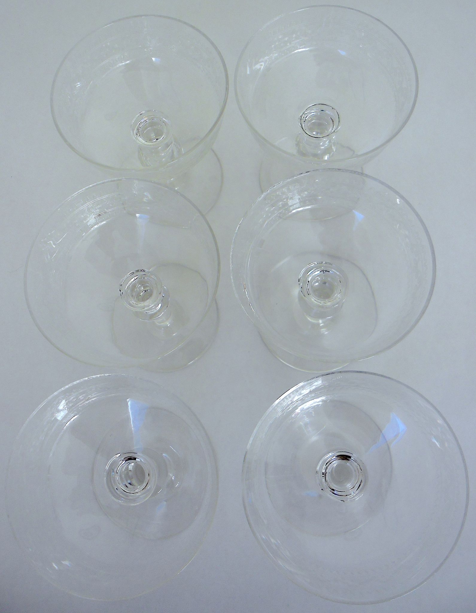 Suite of six champagne glasses on foot in engraved colorless crystal