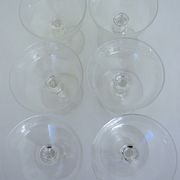 Suite of six champagne glasses on foot in engraved colorless crystal