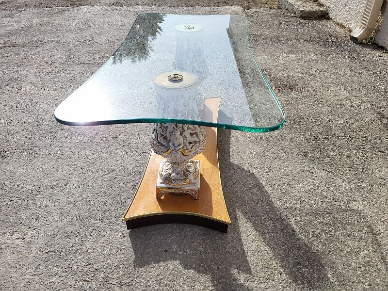 Italian coffee table with glass top, wooden base, and porcelain legs