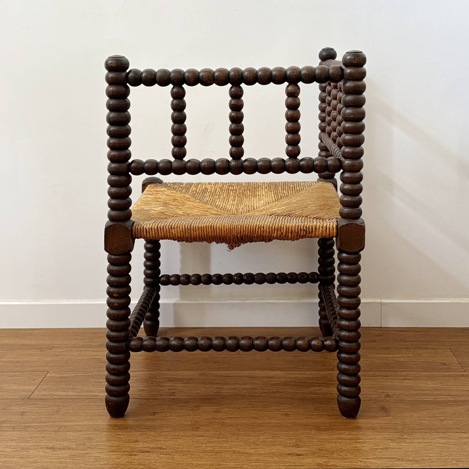 Turned wood corner chair with straw seat