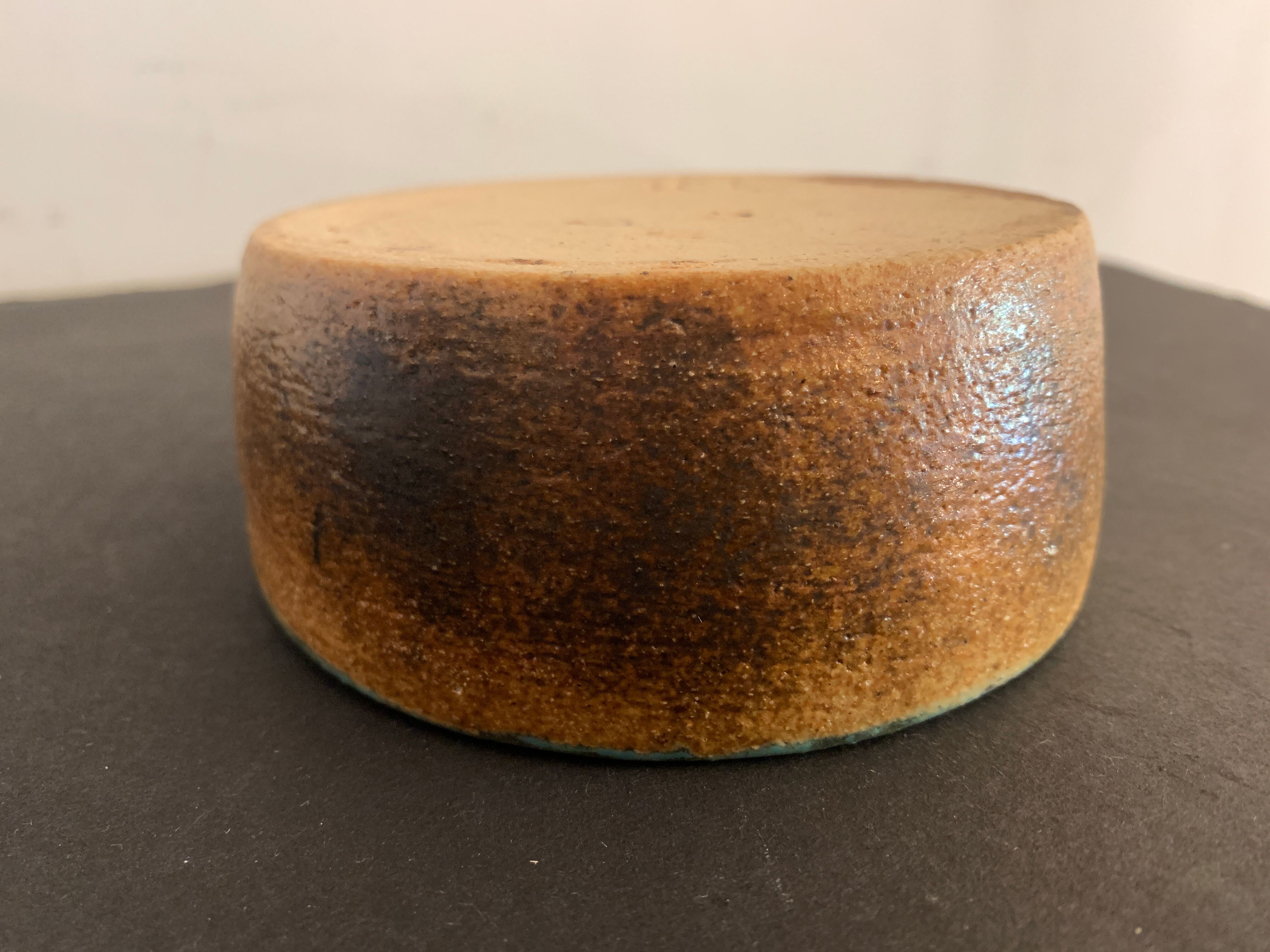 Round ashtray signed in sandstone with glazed interior