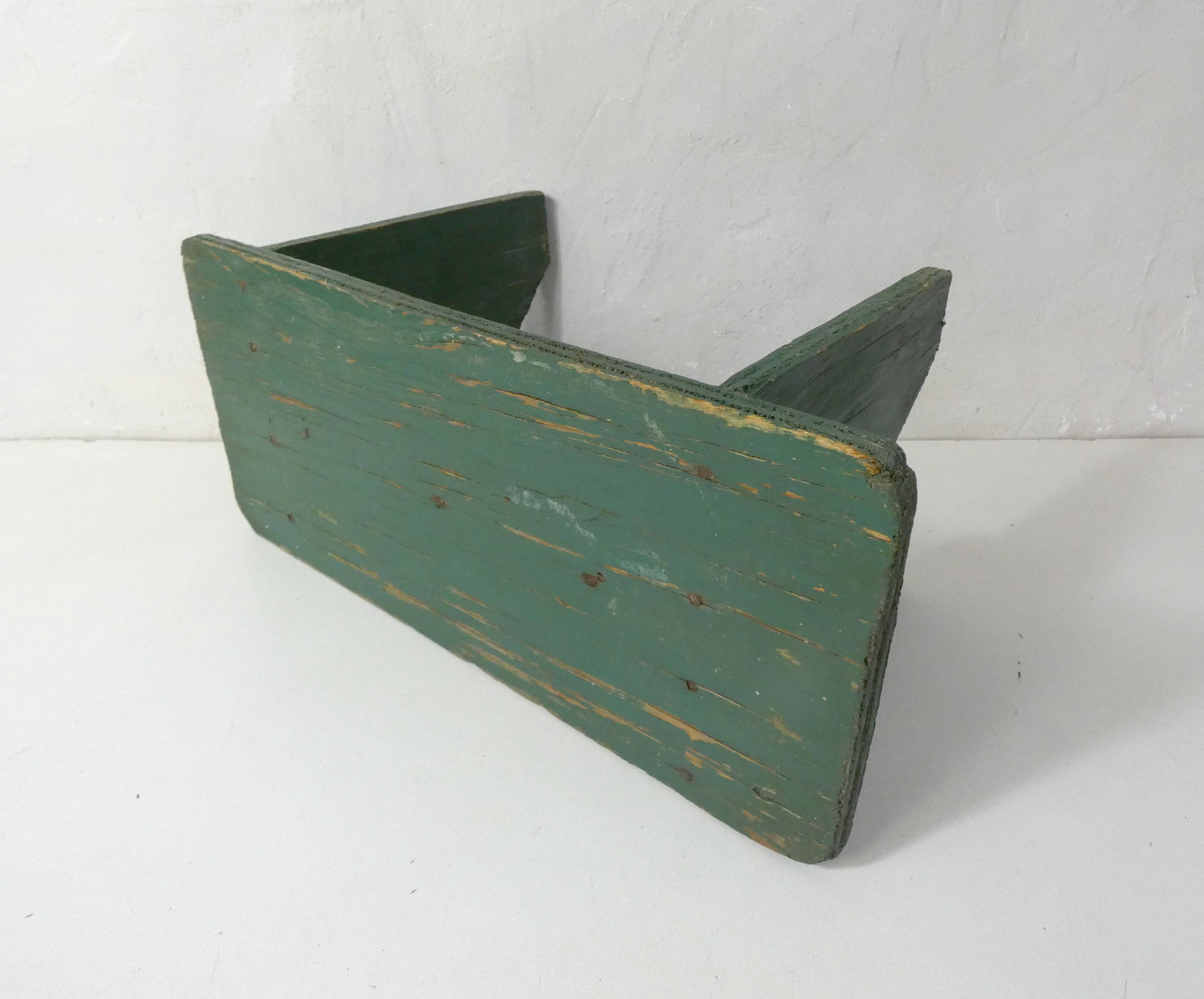 Old small wooden bench with green foot