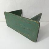 Old small wooden bench with green foot