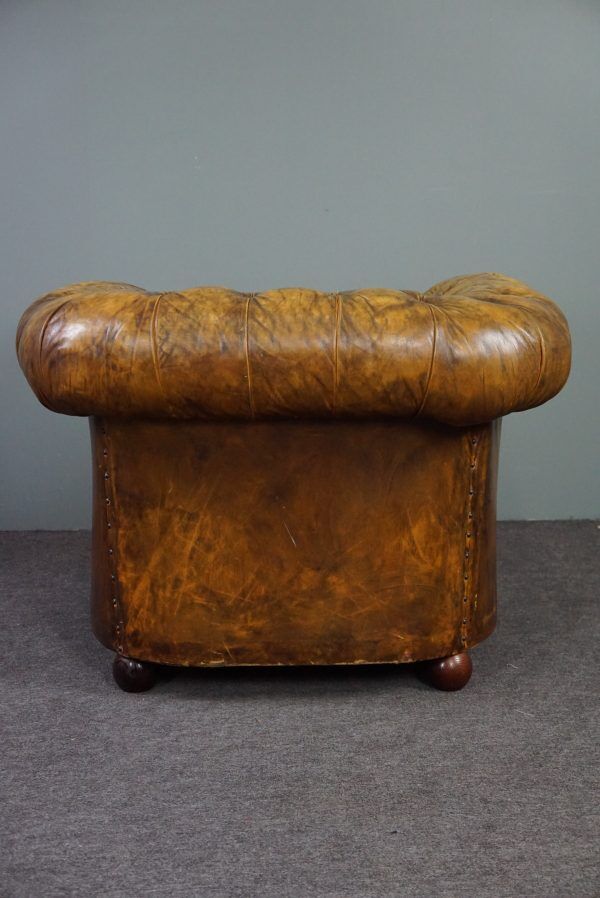Patinated Chesterfield armchair