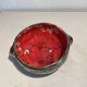 Deep red glazed and metallic ceramic catchall.