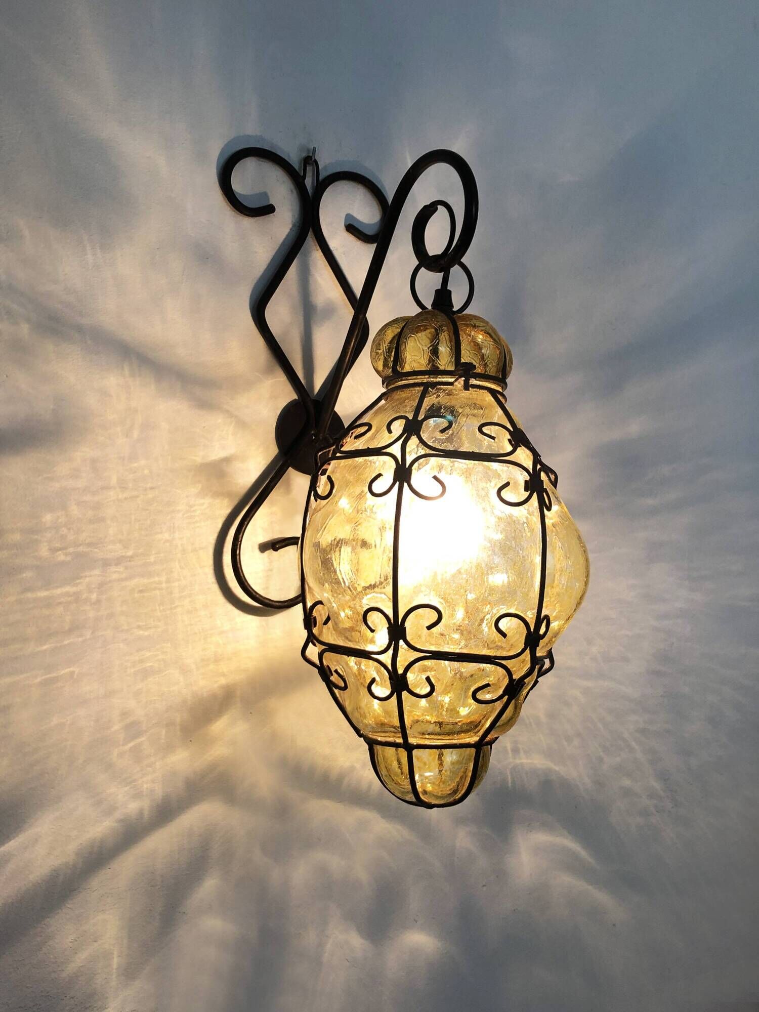 Vintage Italian wall light in transparent yellow blown glass and wrought iron. 70s 80s