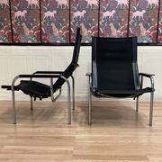 PAIR OF BLACK LEATHER AND CHROME ARMCHAIRS BY HANS EICHENBERGER 1960.