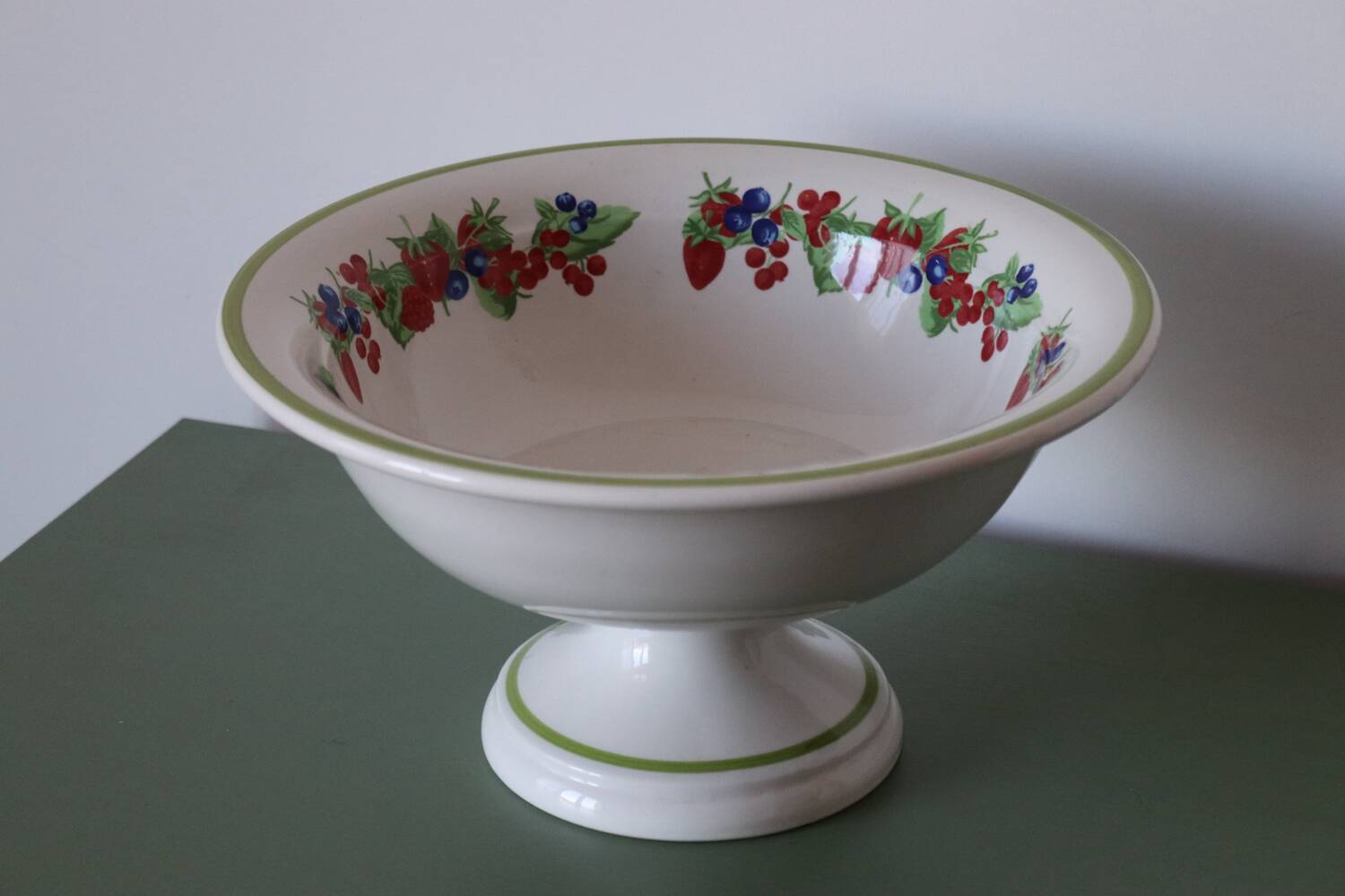 Large ceramic fruit bowl with red fruits