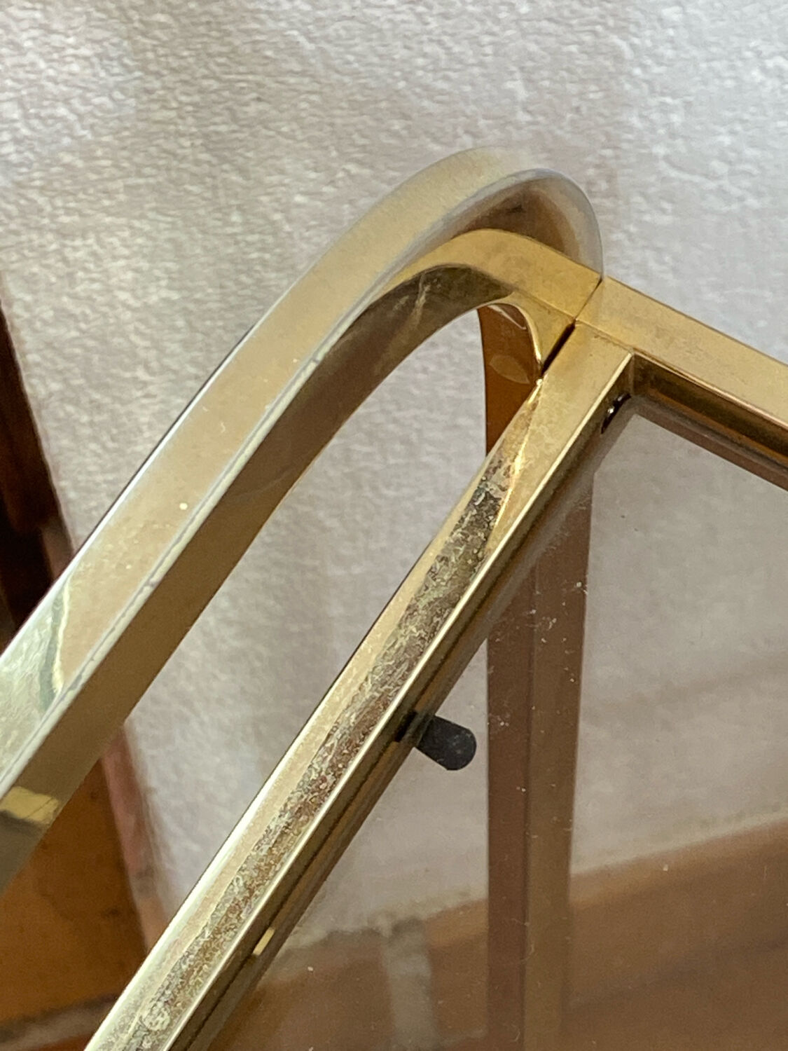 Gold metal and smoked glass console table.