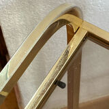 Gold metal and smoked glass console table.