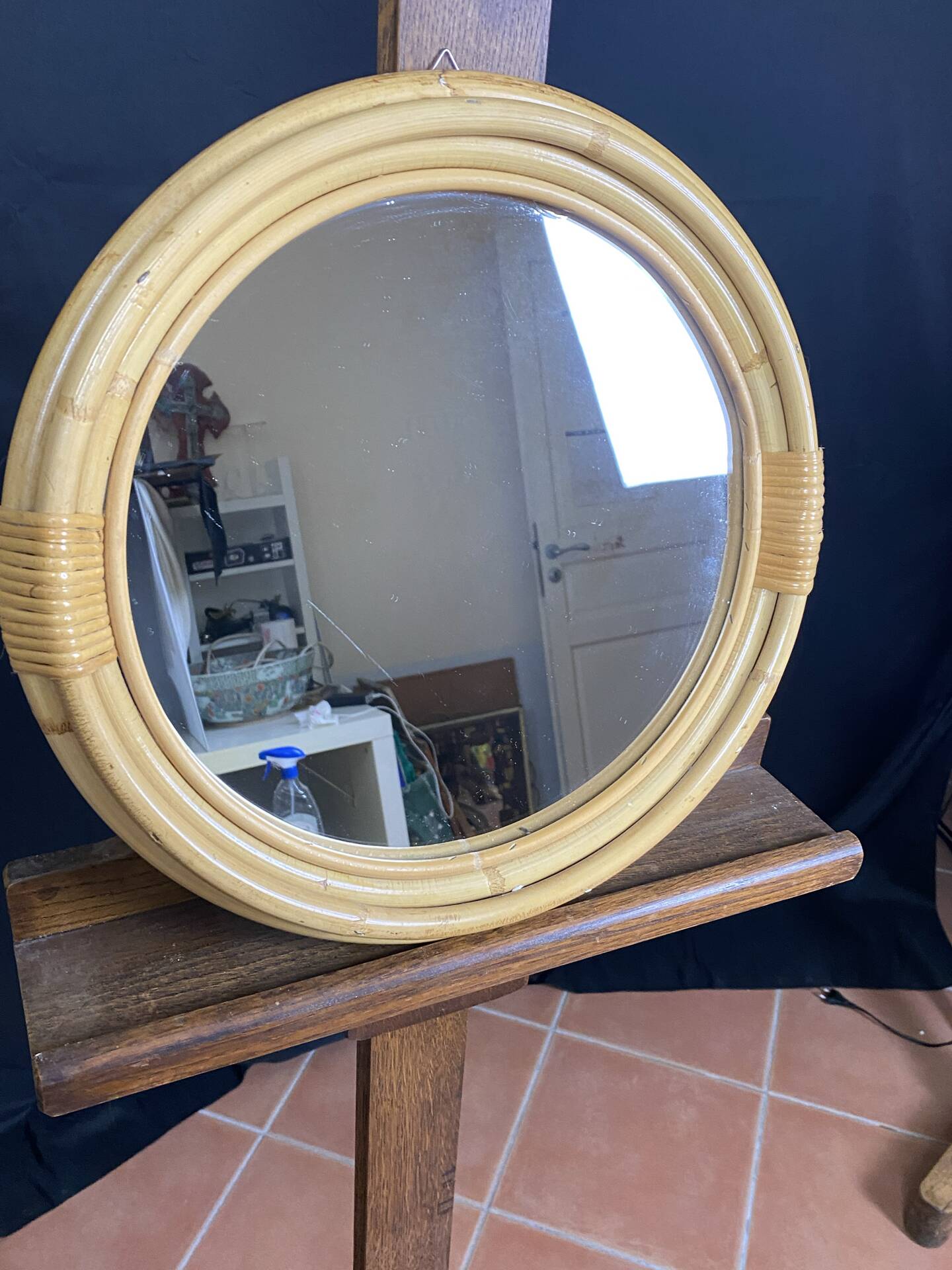 Round mirror from the 1960s with a frame made of rattan and metal.