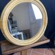 Round mirror from the 1960s with a frame made of rattan and metal.