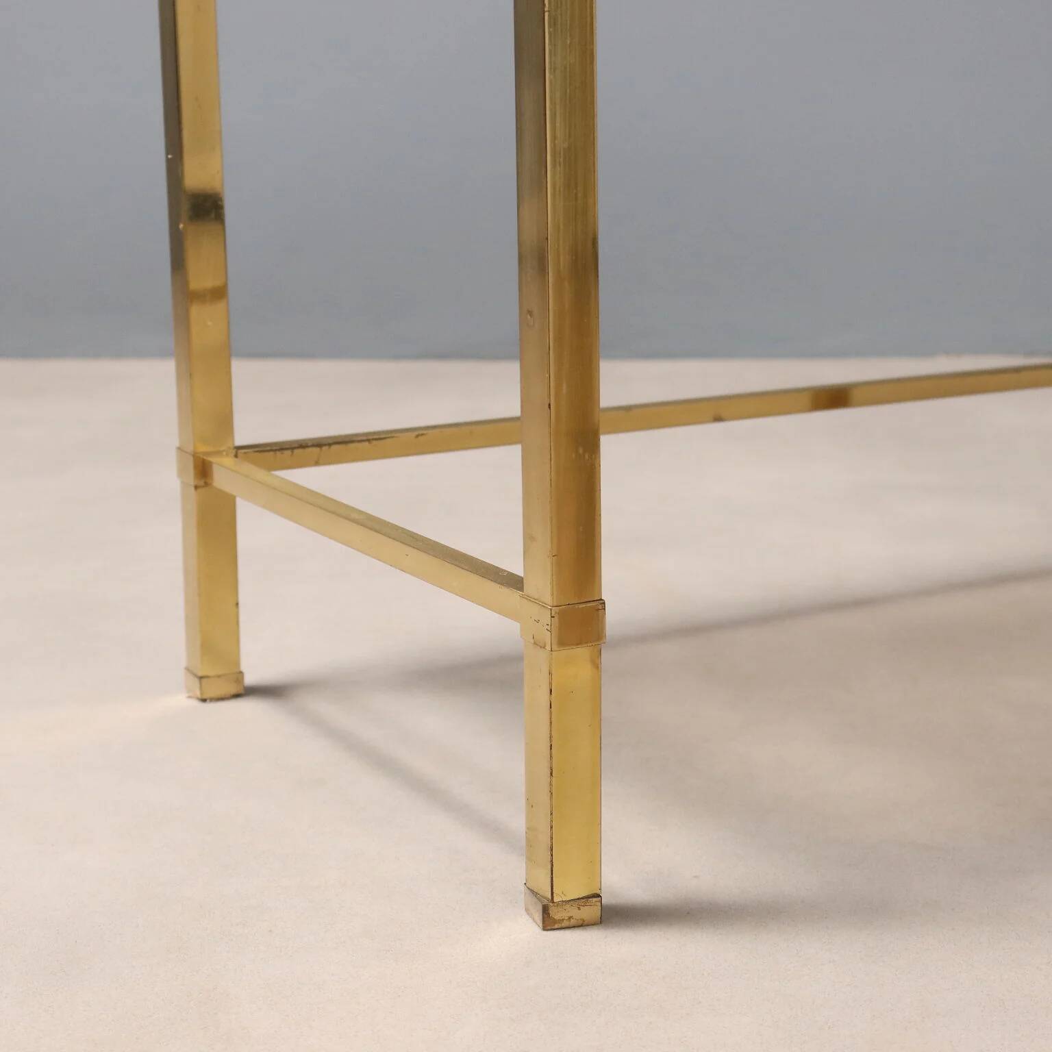 Nested tables in brass and smoked glass.