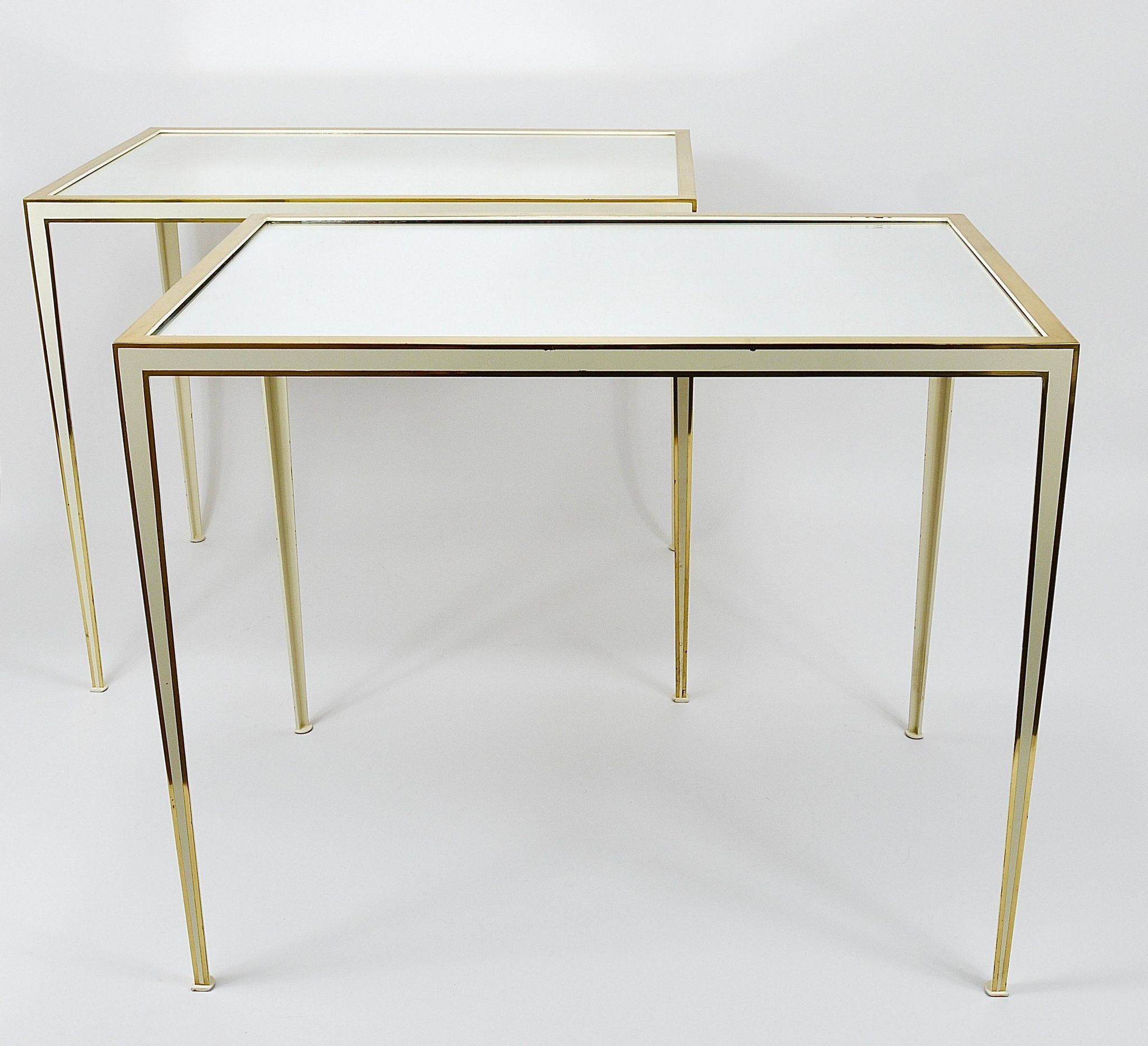 A pair of brass and white mirror tables from Vereinigte Werkstätten, Germany, 1970s.