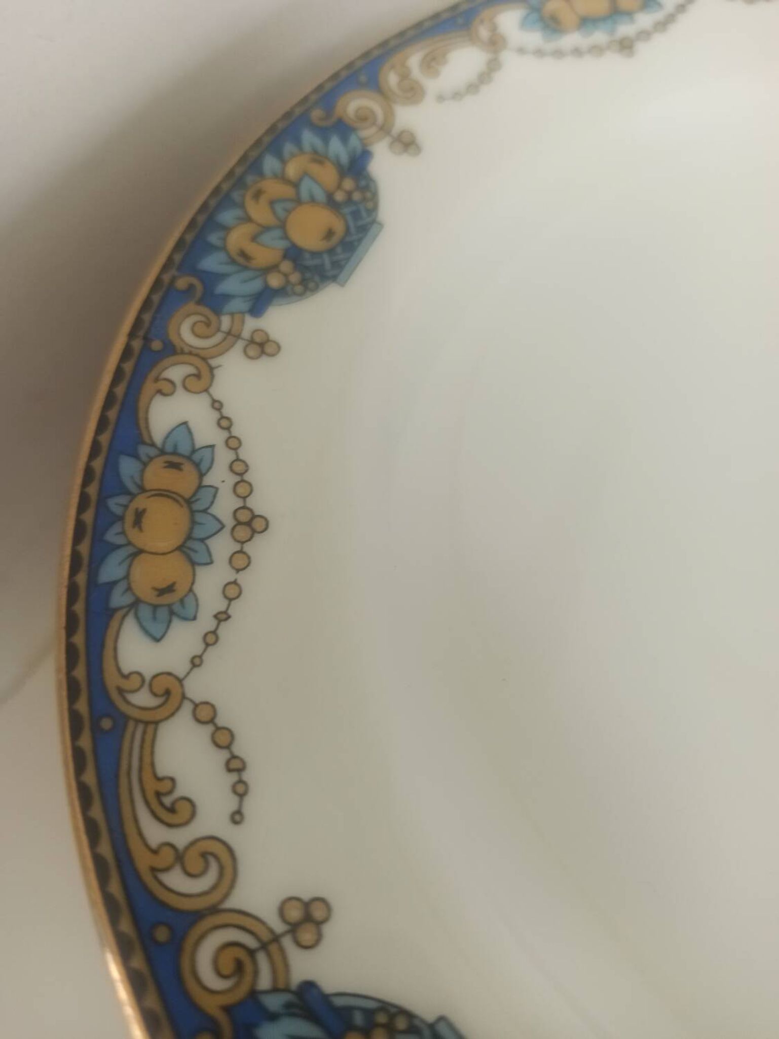 12 assiettes en porcelaine de Limoges à décor de guirlandes et de fruits
