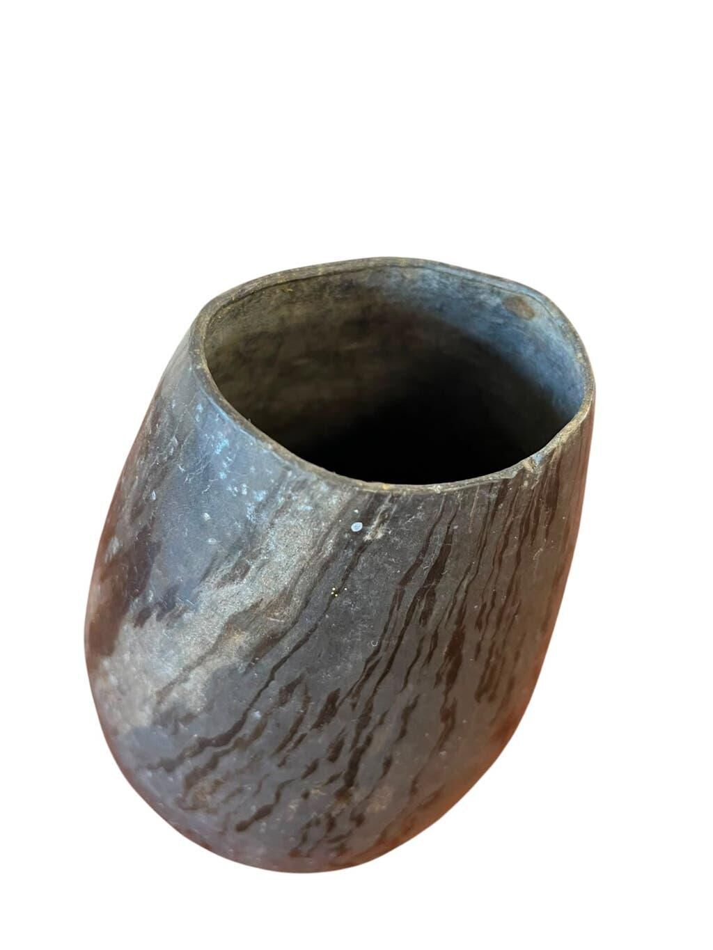 Vintage stone vase with worked fossil