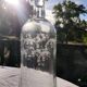 Two antique engraved glass bottles