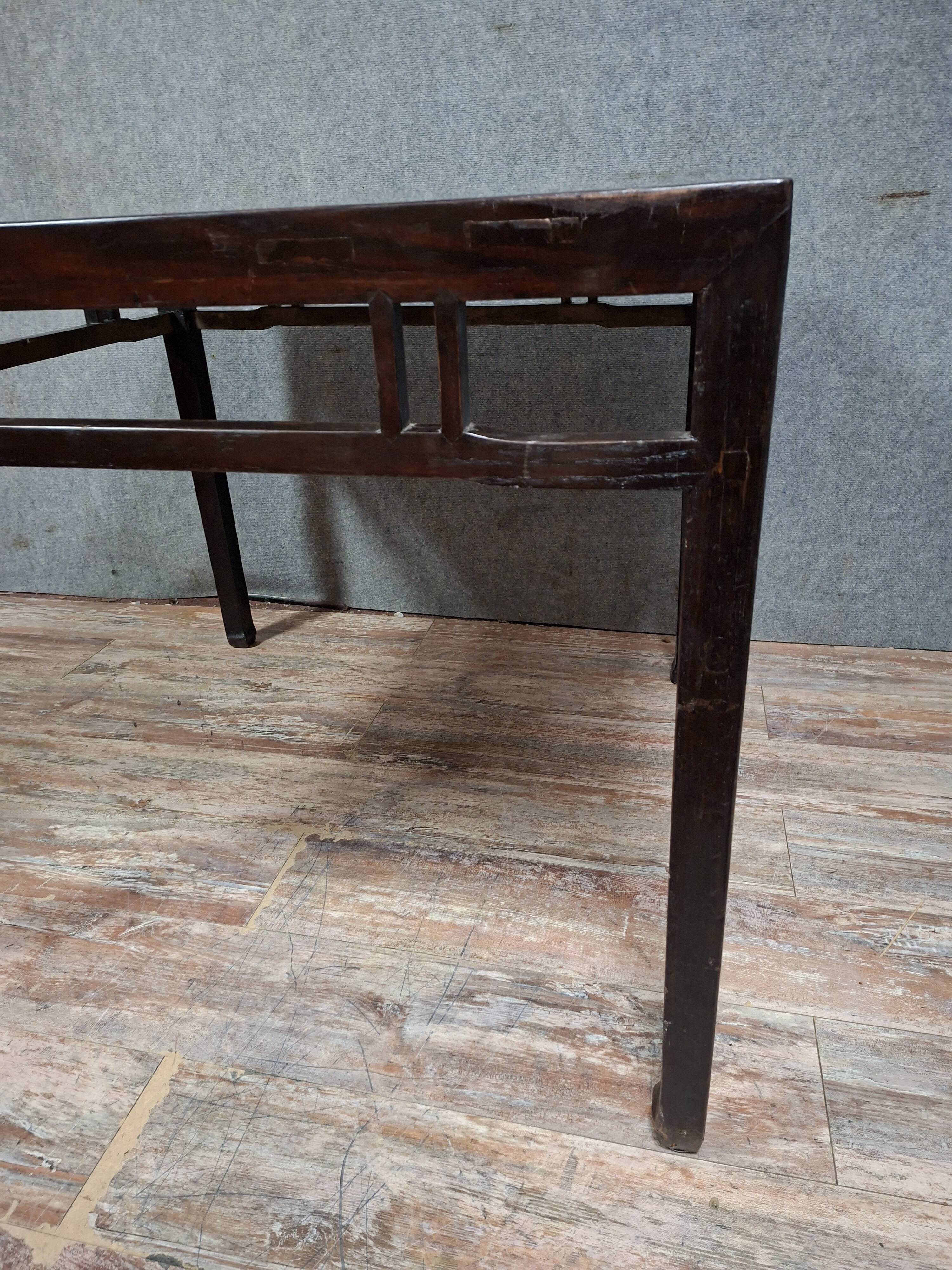 ancient Asian table, made of solid wood with a dark brown patina