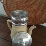 Old tea pot or coffee maker in faience cream with filter.